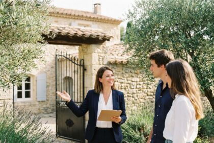 Agent immobilier ARE Immo présentant une maison en pierre traditionnelle à Ganges dans l'Hérault à un couple d'acheteurs